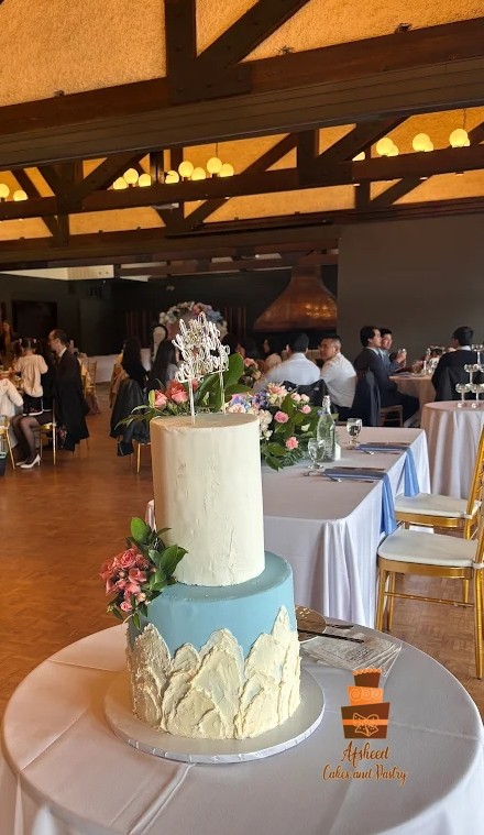 Custom handmade wedding cake for 100 guests by Afsheed Cakes and Sweets, with patterns of mountains and Canadian Rockies on the side
