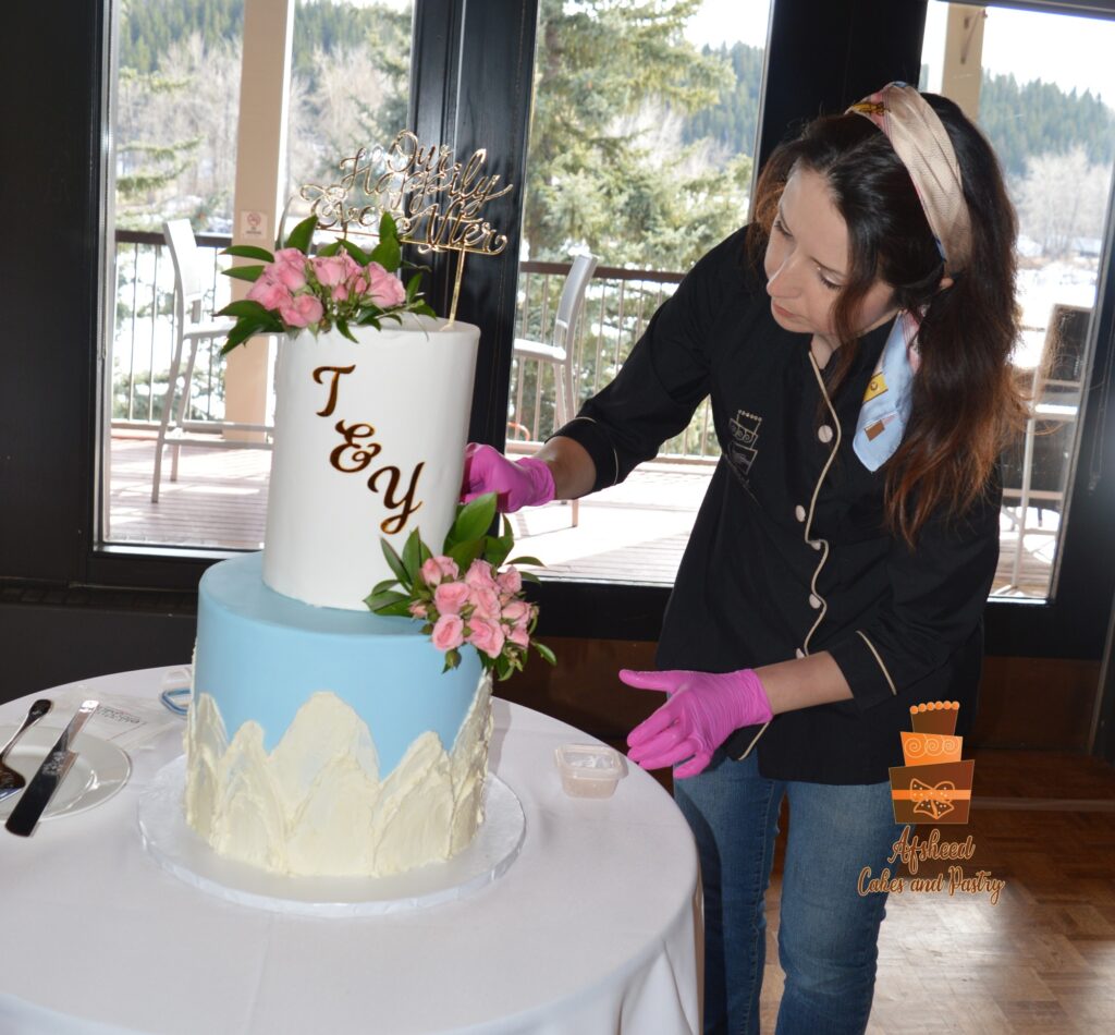 Chef Afrand of Afsheed, focused on wedding cake delivery and setup at Calgary Waterfront Park Pavilion