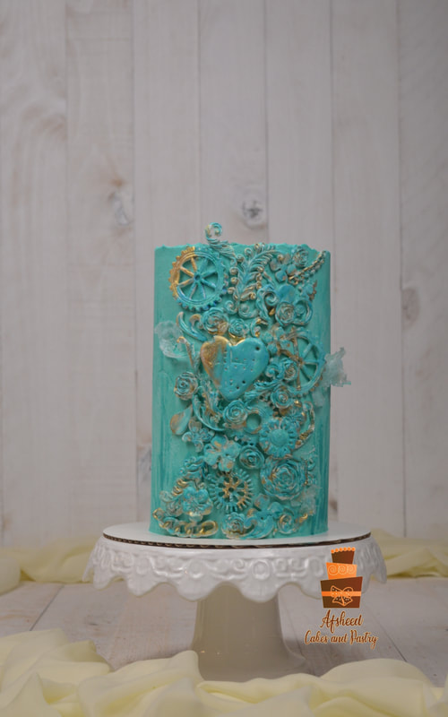 Custom tall cake with Post modern design and textures in gold and teal colors, made by Afsheed Custom cakes. One the highest ranking and most experienced cake artists in Canada, Alberta, Calgary.