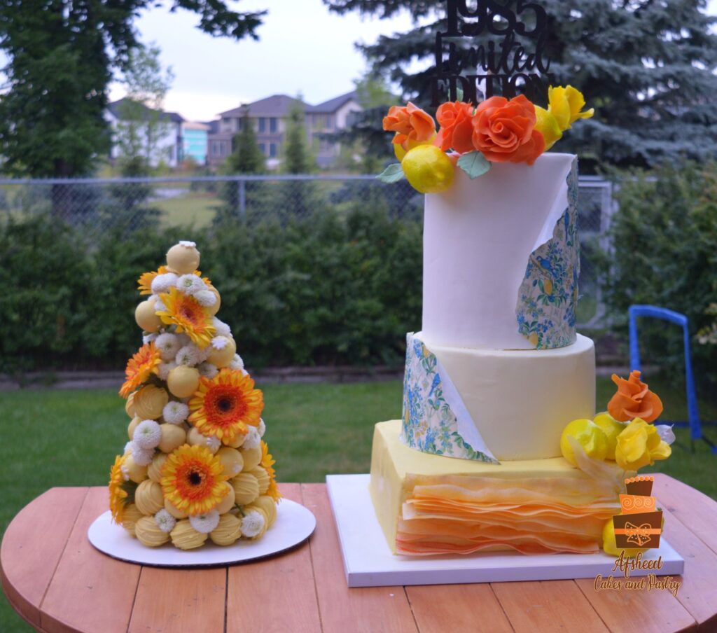 Lemon-themed luxury birthday cake and candy bar with cake pops, Persian sweets, and fresh summer treats – Afsheed custom dessert table in Calgary.