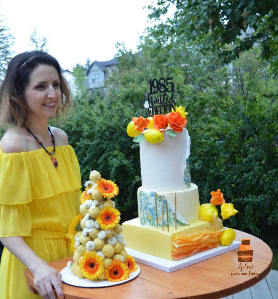 Lemon-themed luxury birthday cake and candy bar with cake pops, Persian sweets, and fresh summer treats – Afsheed custom dessert table in Calgary.