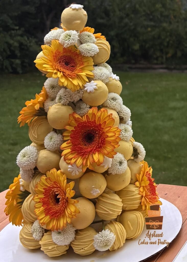 A closer look at the Cake Pop Tower, next to the birthday cake and candy bar, Persian sweets – Afsheed custom dessert table in Calgary.