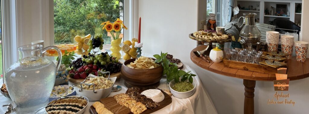 Luxury candy bar dessert table in Calgary featuring Persian sweets, homemade lemonade, savory appetizers, cake pops, and custom lemon-themed birthday treats by Afsheed