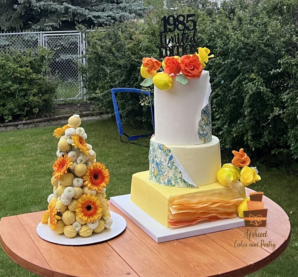 Lemon-themed luxury birthday cake and candy bar with cake pops, Persian sweets, and fresh summer treats – Afsheed custom dessert table in Calgary.