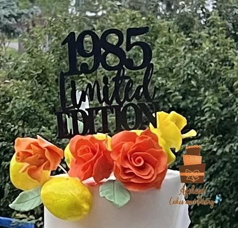 A closer look at the topper and the top tier of my Lemon-themed luxury birthday cake  – Afsheed custom dessert table in Calgary.