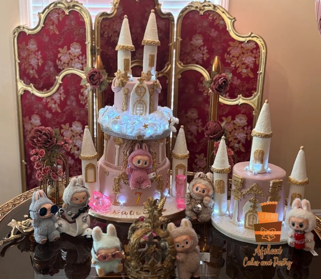 Custom Labubu Cake Calgary, pink and gold castle birthday cake with handmade details and Labubu dolls, perfect for luxury kids’ parties