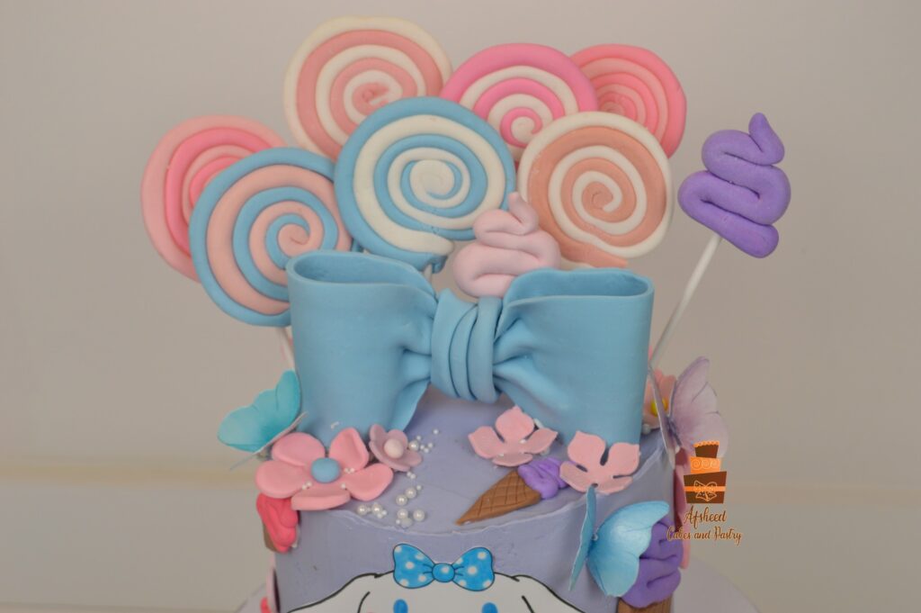 Custom Labubu and Sanrio birthday cake with handmade candy, pastel lollipops, and fondant bow by Afsheed Cakes and Pastry Calgary