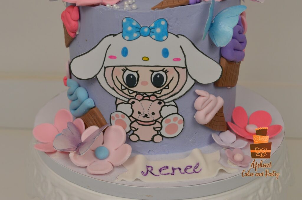 Cute Labubu x Sanrio themed cake with pastel fondant lollipops, blue bow, and personalized name design from Afsheed Bakery Calgary