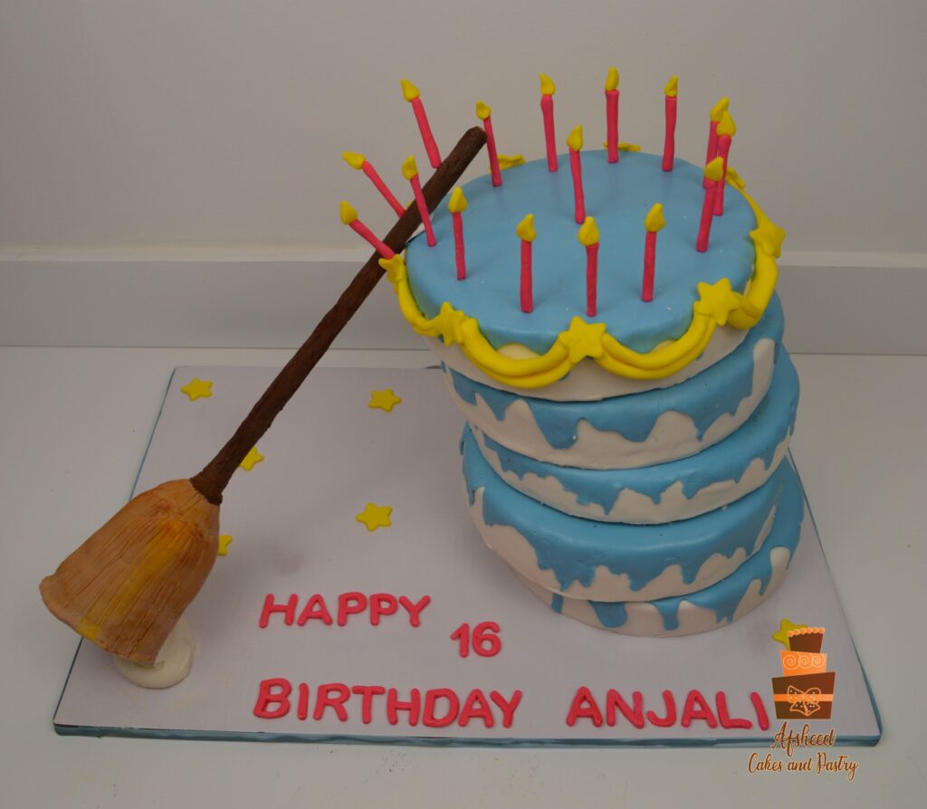 Whimsical Cinderella Broom Cake with stacked wobbly tiers and handmade edible broom, Calgary custom cake