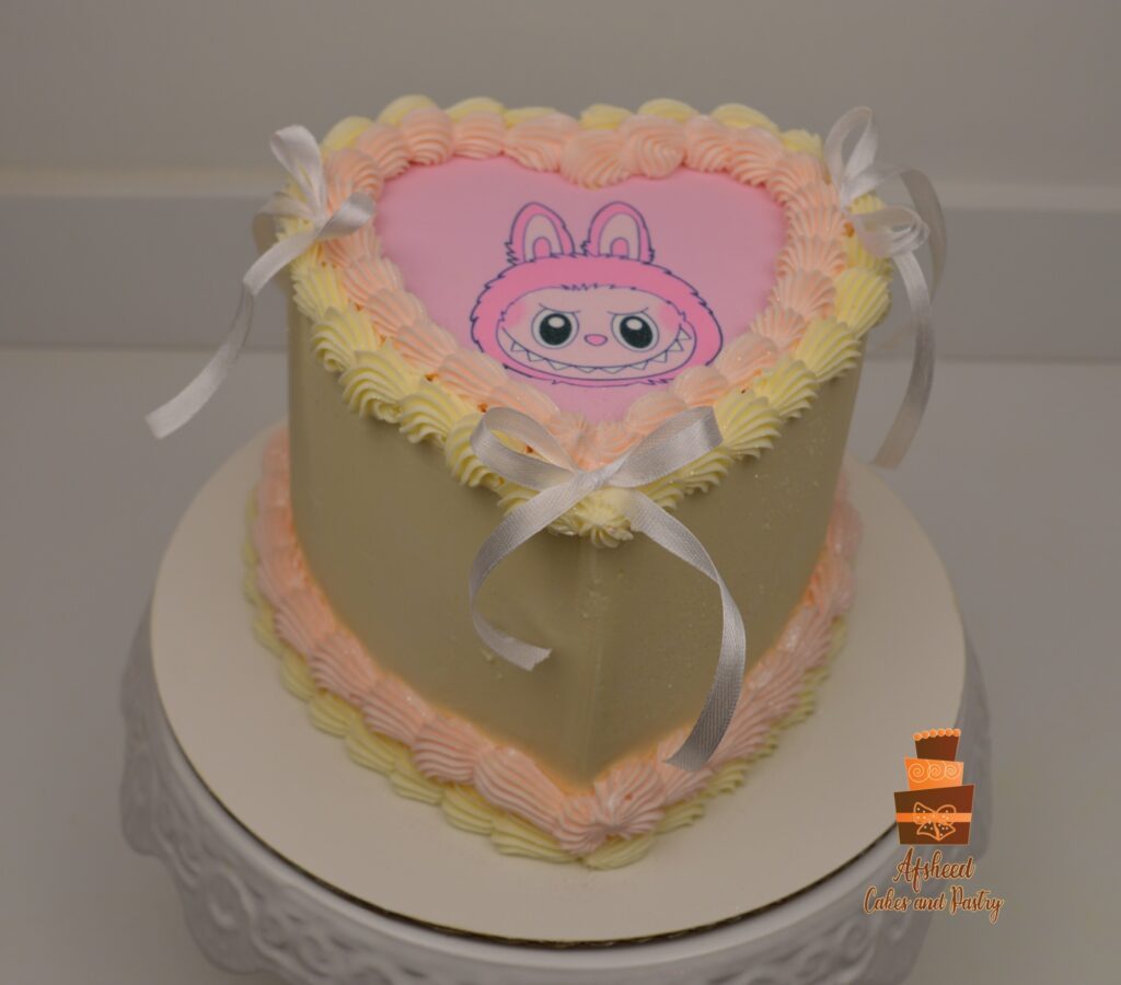 Simple heart shaped cake with an edible print of a pink Labubu