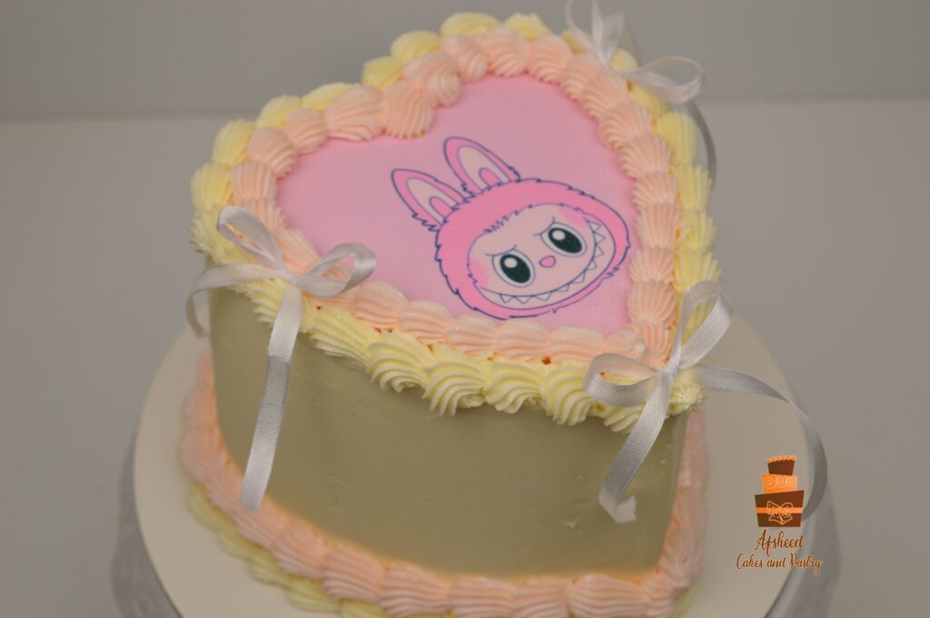 Simple heart shaped cake with an edible print of a pink Labubu