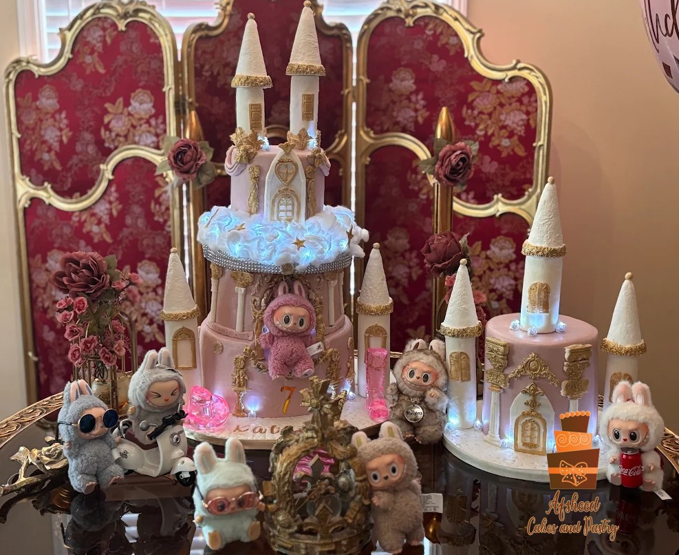 Custom Labubu Cake Calgary, pink and gold castle birthday cake with handmade details and Labubu dolls, perfect for luxury kids’ parties.