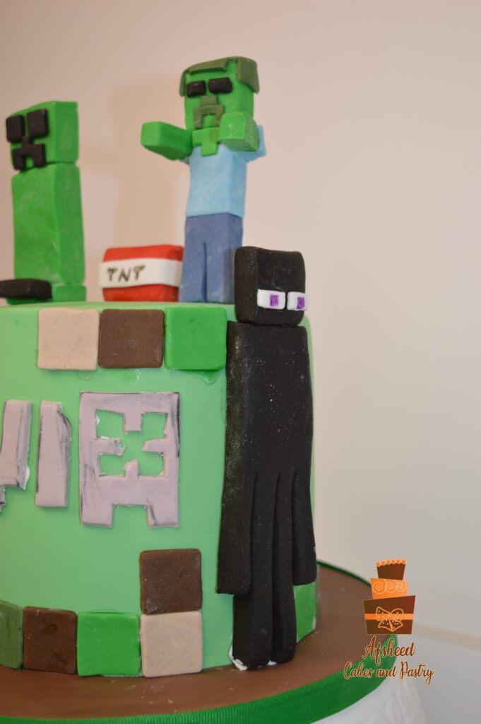 Pixel-style Minecraft cake for boys featuring handcrafted game characters and fondant decorations