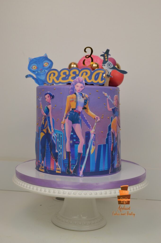 K-Pop Demon Hunters Huntrix themed girl birthday cake with edible prints of Rumi, Mira, and Zoey handmade in Calgary