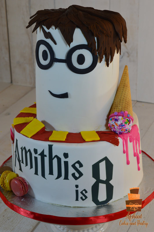A large two tiered tall Harry Potter–themed birthday cake decorated in Gryffindor colors with the harry potter face and hair created in ROBLOX theme and as a ROBLOX character,
upside down melting ice cream cone, edible photo on cake shows a custom birthday message by Afsheed Cakes and Pastry in Calgary