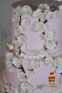 Custom wedding cake in blush pink and cherry blossoms