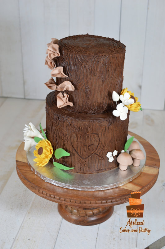 Rustic tree stump wedding cakes Calgary - Two-tier chocolate buttercream cake sculpted to look like a realistic tree log with "engraved" heart initials, edible mushrooms, sunflowers, and sugar fungi by Afsheed cakes, in Calgary for couples seeking a unique, nature-inspired, or woodland-themed luxury wedding cake.
