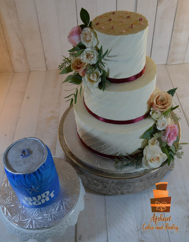 Wedding cake near me - Majestic four-tier white fondant wedding cake with rose gold glitter accents and pastel sugar flowers, featuring a custom 3D Bud Light can groom's cake, delivered to the Calgary Hellenic Community Association by Afsheed cakes, in Calgary for couples seeking the highest rated custom bakery for a grand celebration with a fun, personalized twist.