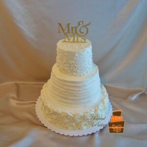 Multi-textured buttercream wedding cakes Calgary - Three-tier white cake featuring a pearl-studded top tier, a rustic horizontal ribbed middle tier, and a bottom tier of piped buttercream rosettes, finished with a gold glitter "Mr & Mrs" topper by Afsheed cakes, in Calgary for couples seeking a classic, elegant, and highly textured custom wedding cake.