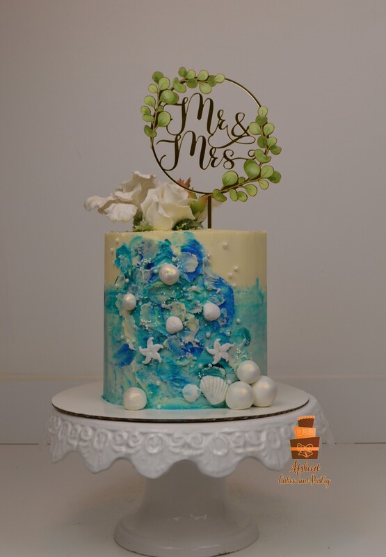 Small wedding cake with ocean and diving theme and a custom cake topper, made by Afsheed Home bakery, home of the most personalized wedding cakes in Calgary, Banff, Canmore